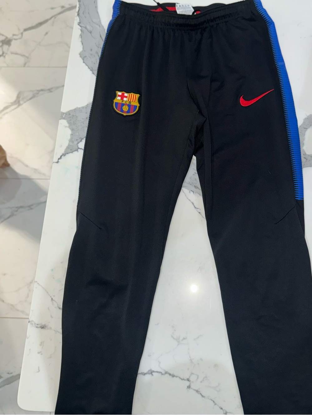 Nike Kids Black Joggers with Blue Trim and Red Swoosh